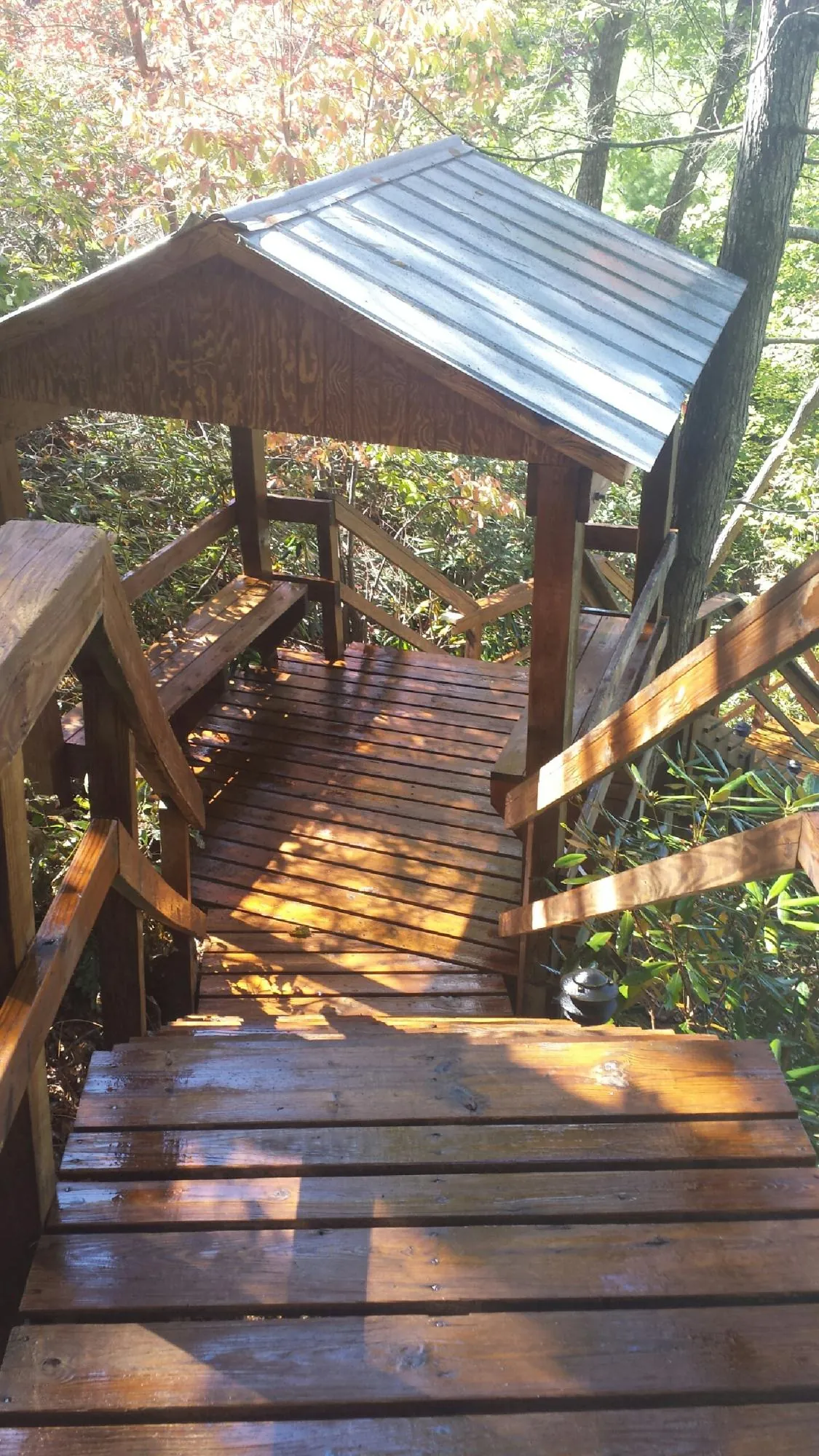 Freshly stained wood walkway and covered shelter with a metal roof in Warrior